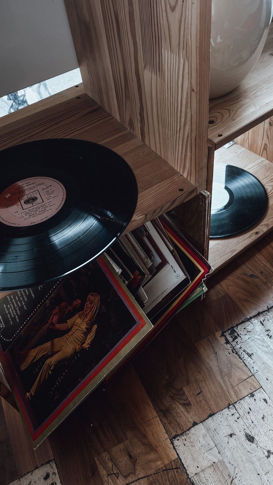 A record collection beside a turntable